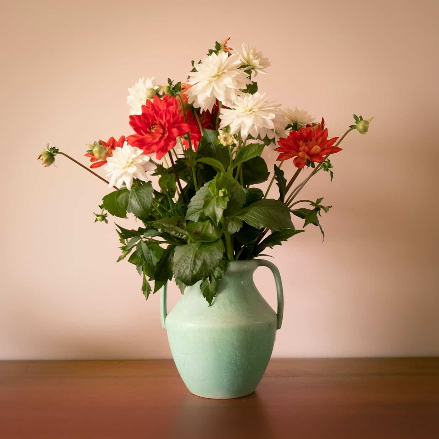 Garden flowers in a sage green jug